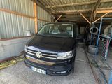 a black vw van parked in a garage