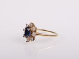 an image of a blue sapphire and diamond ring on a white surface