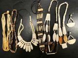 several different types of necklaces on a table with a black background