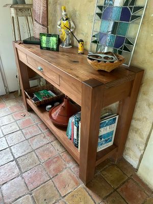 a wooden table with a basket on top of it
