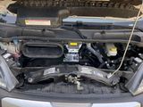 a car with the hood open and the engine in the back