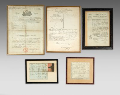 several old documents are hung on a wall in a room