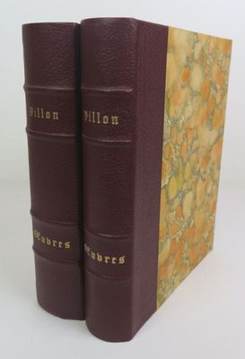 the two books are sitting side by side on a white surface