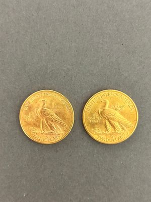 two gold coins, one with a bird on it and the other with a bird on it