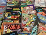 a lot of comic books on the table together