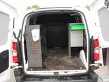 a white van with the back door open and a green box in the back of the van