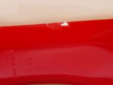 the bottom of a pair of red high heeled shoes on a white surface