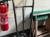 a fire extinguisor next to a bench in a garage