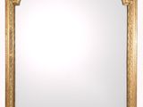 an ornate gold mirror with a white background and a gold frame