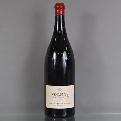a bottle of red wine sitting on top of a glass table