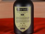 a bottle of wine sitting on a red cloth