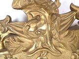 a gold clock that has a face on it