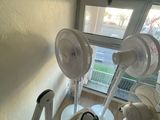 three fans that are sitting on the stairs of a building