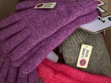 several gloves are stacked on top of each other in a cardboard box