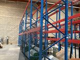 a large warehouse with lots of shelves and pallets