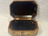 a small wooden box with a mirror inside of it
