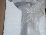 a toilet in a box wrapped in plastic