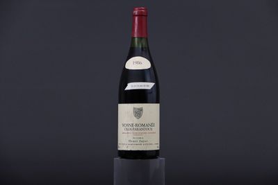 a bottle of wine sitting on top of a black table