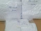 a pile of white towels sitting on top of a cardboard box