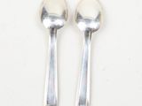 two spoons that are sitting next to each other