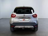 the rear end of a silver car in a white room