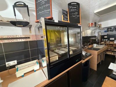 une photo de la cuisine d'un restaurant avec un comptoir et un réfrigérateur