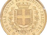 a close up of a gold coin with a crown on it
