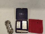 a small case with a razor, razor blade, and other items