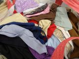 a pile of clothes in a bag on the floor