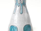 un vase blanc orné d'un motif bleu et jaune