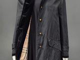 a black coat with a fur collar and a checkered scarf