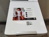 a white washing machine sitting on a pallet in a room