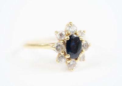 an image of a sapphire and diamond ring on a white background