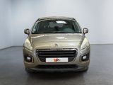 the front view of a silver car in a room with a white wall