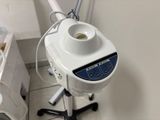 a hair dryer sitting on a stand in a bathroom