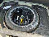 the inside of a car with a tire and a bunch of screws in it