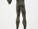 statue of a man holding a baseball glove on a wooden base