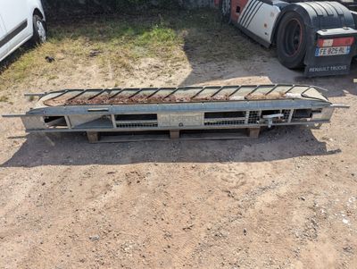 a truck that is parked in the dirt with a flat bed