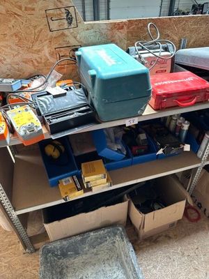 many tools on a shelf in a garage