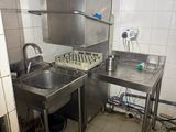 a small kitchen with a sink and a stove in it