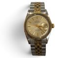 an image of a gold and silver wrist watch on a white surface