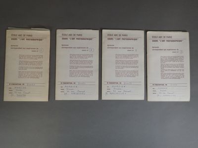 three papers are lined up on a gray surface