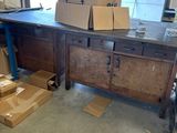 boxes are stacked on top of a workbench in a garage