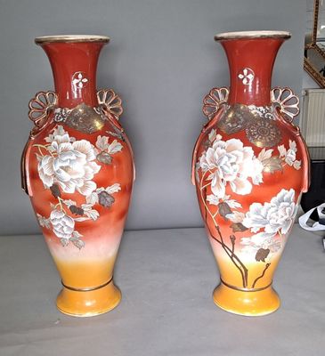 two vases that are sitting on a table