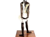 statue of a man in a tutu standing on a wooden base