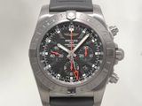 a black watch with a red second hand on a black rubber strap