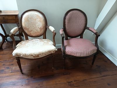 two chairs sitting next to each other on a hard wood floor