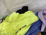a pile of clothes sitting on top of a wooden table