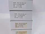 four boxes of new and unused dental supplies on a white surface
