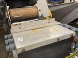 a machine that has a conveyor belt in the middle of it